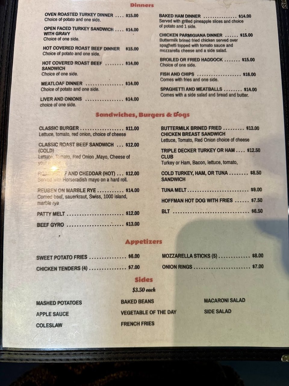 Menu board with breakfast, sandwiches, and dinners.